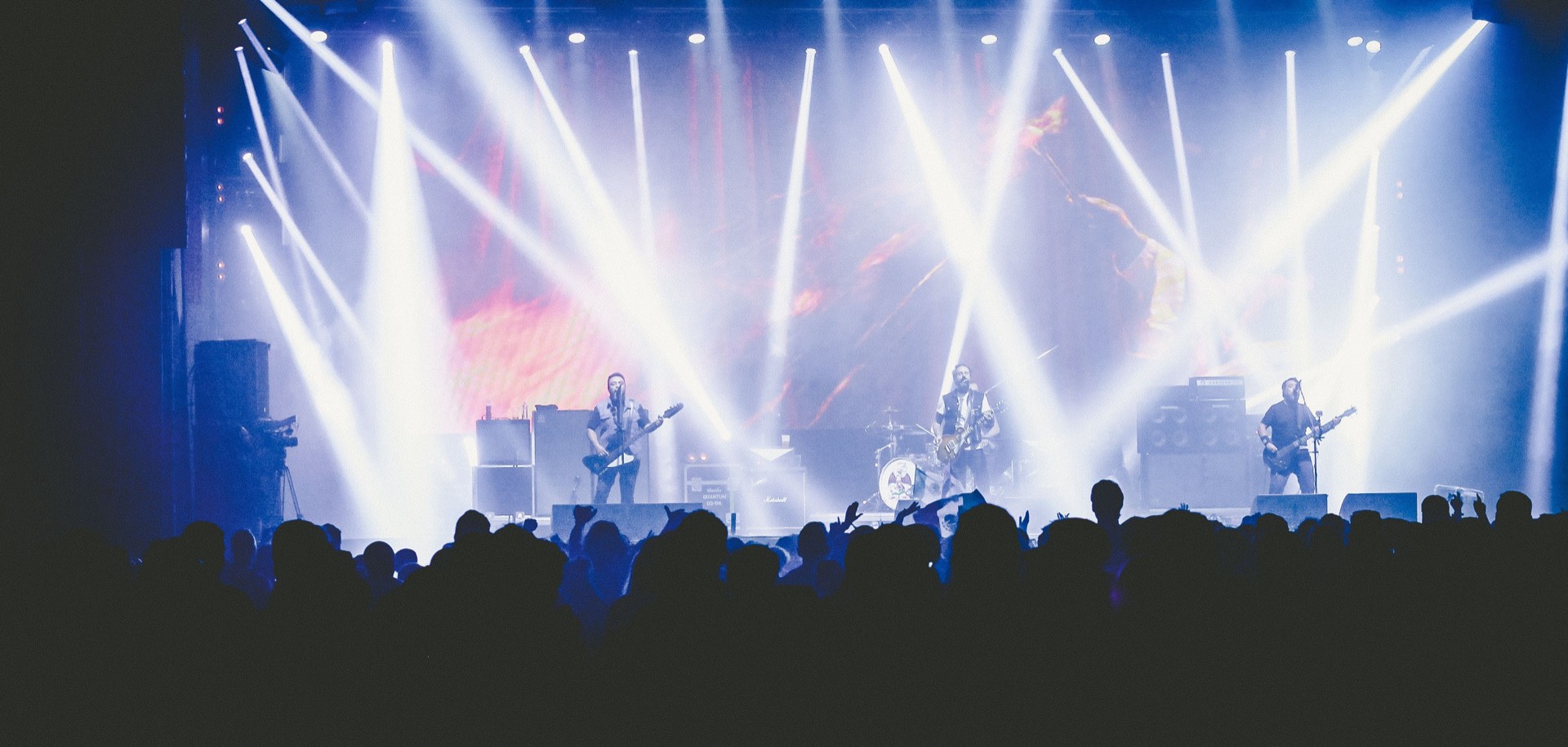 A wide panoramic view of a live crowd at a night event